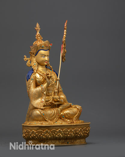 Side view Tsokye Dorje statue showing ornate khatvanga staff and detailed crown finial
