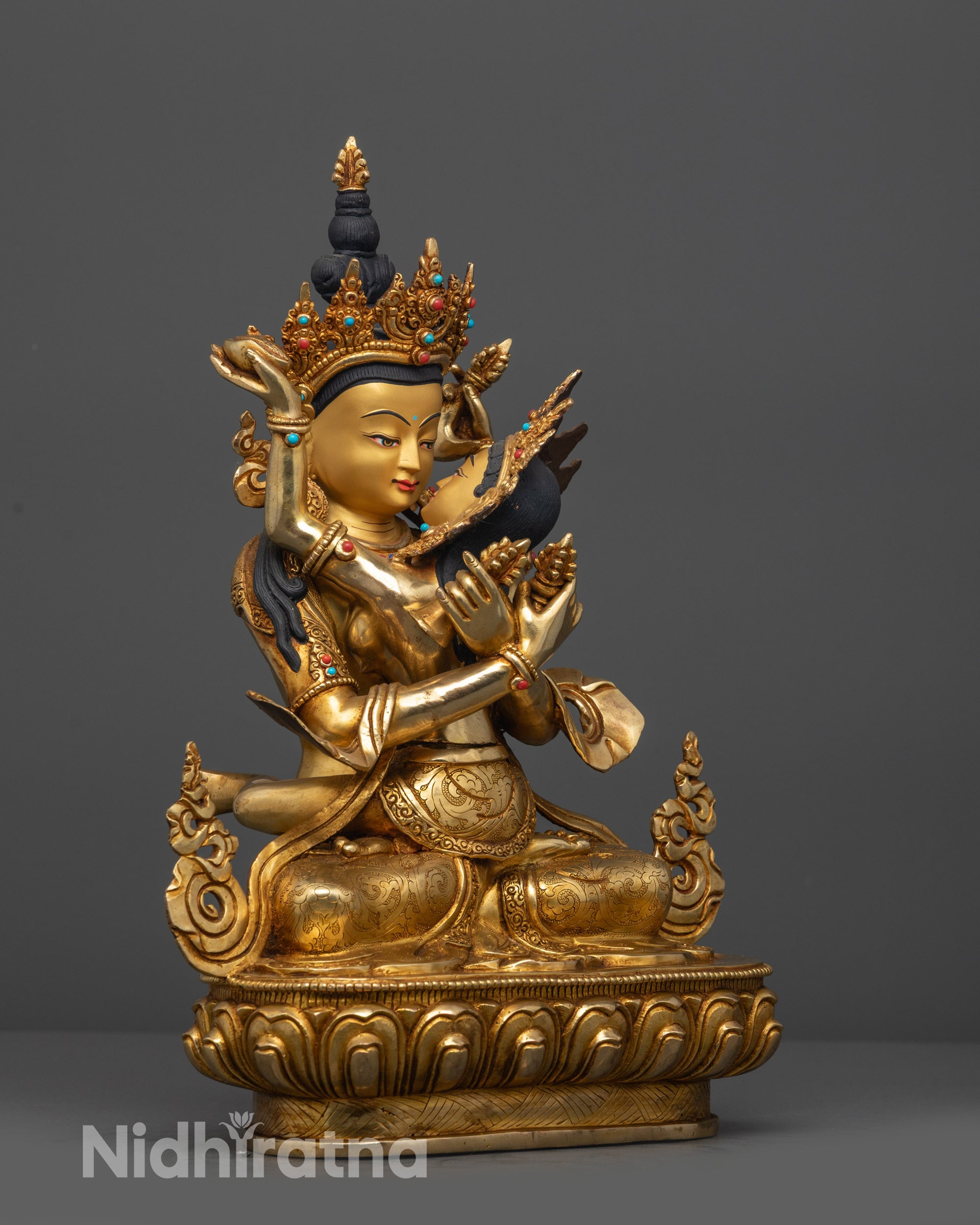 Side view Vajradhara Yab Yum statue seated on lotus with detailed jewelry patterns