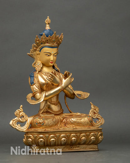 Side view Vajradhara statue highlighting copper body, crossed arms, and intricate details
