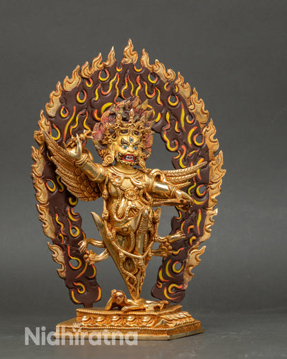 Close up Vajrakilaya face, gold-painted copper, hand-applied acrylic colors, blazing halo