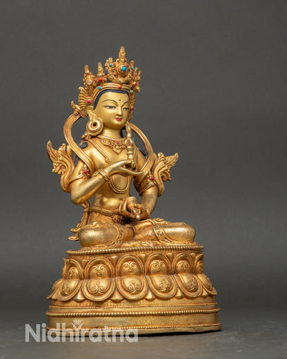 Side view Vajrasattva seated on lotus base holding vajra and bell in meditation