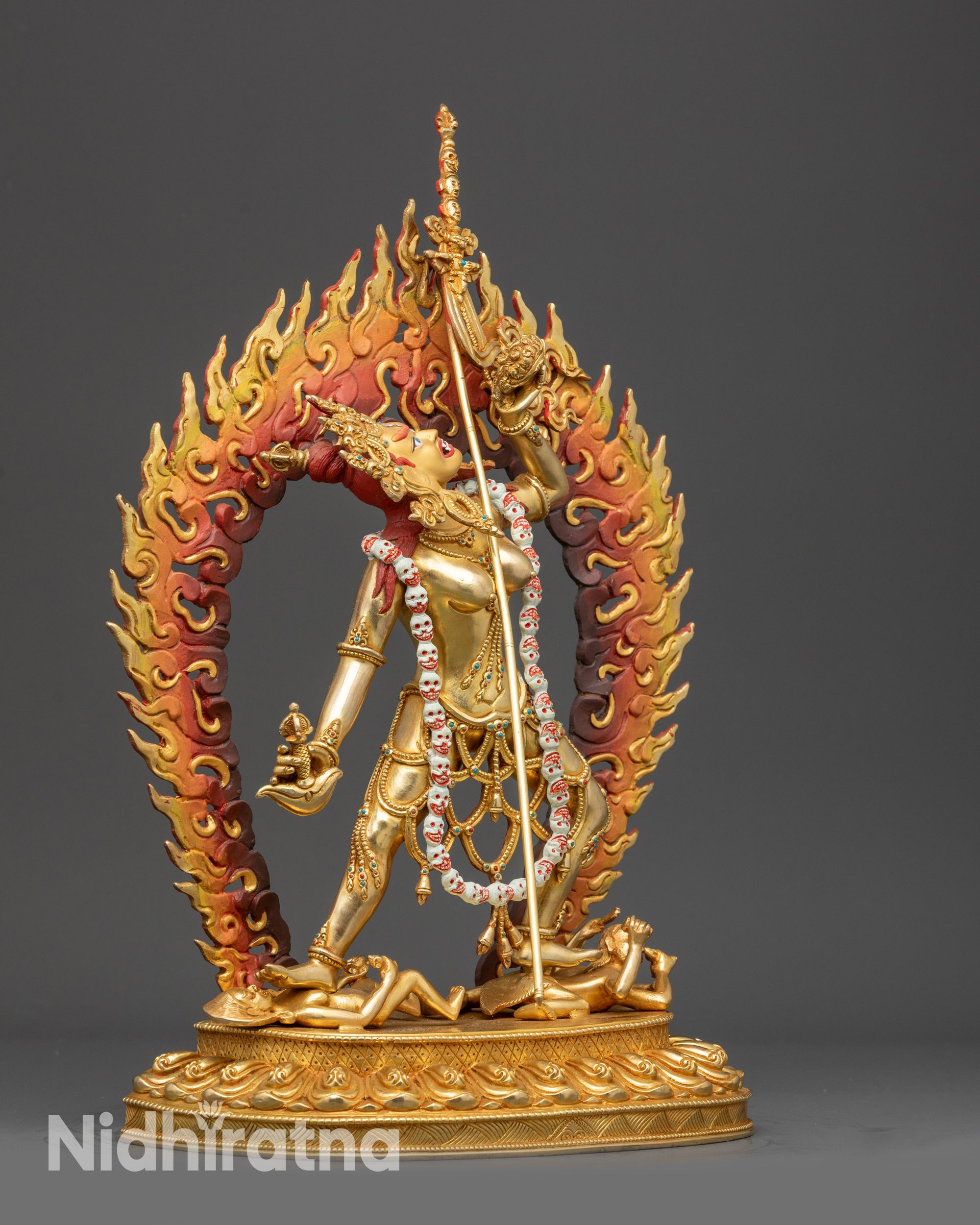 Side view Vajrayogini statue holding kartaika knife, skull cup, and khatvanga staff dynamically

