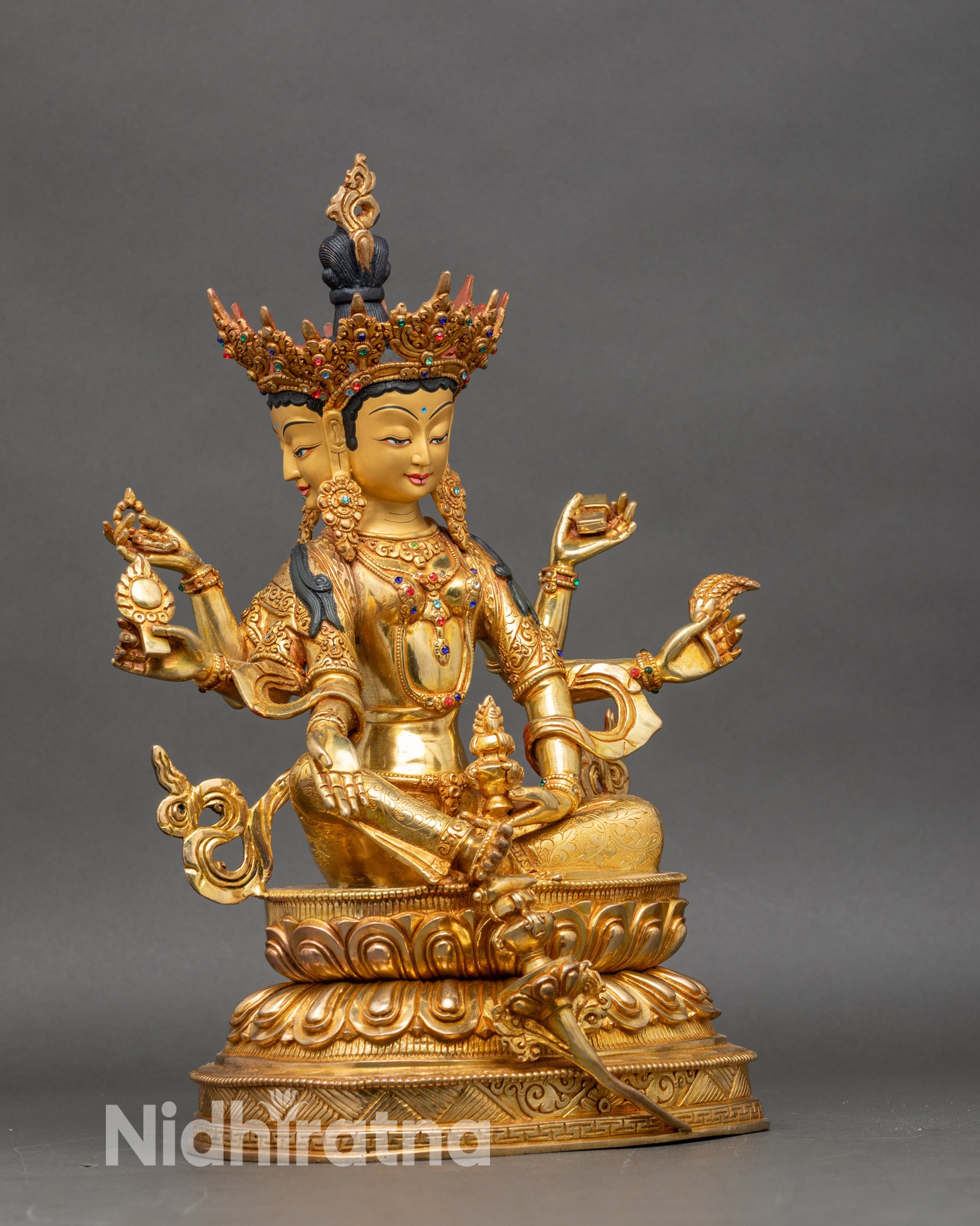 Side view Vasudhara Buddha statue three faces six arms lotus pedestal sacred ritual objects Nepalese art