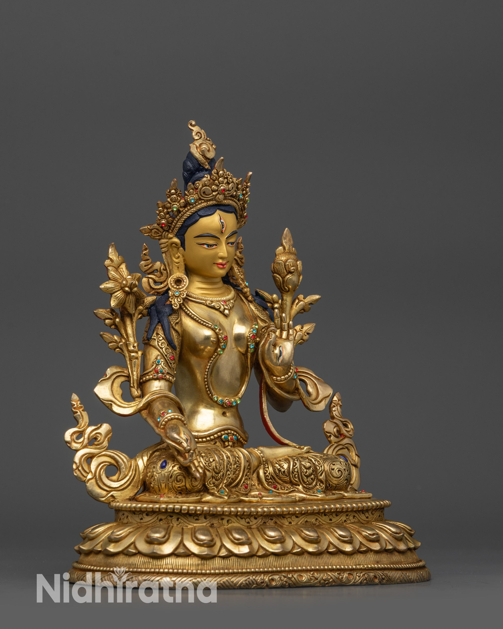 Side view White Tara statue showing flowing robe with semi-precious stones