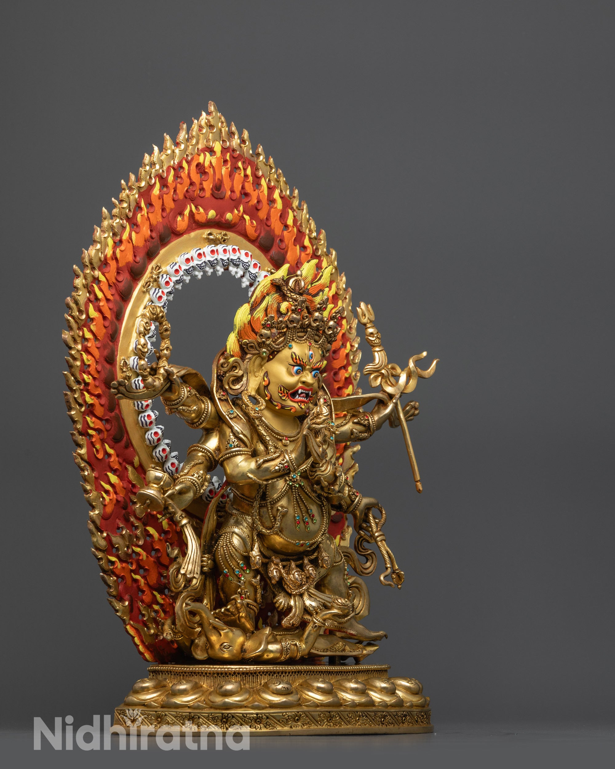 Side view Wrathful Mahakala Statue crushing deities on lotus seat with detailed robes
