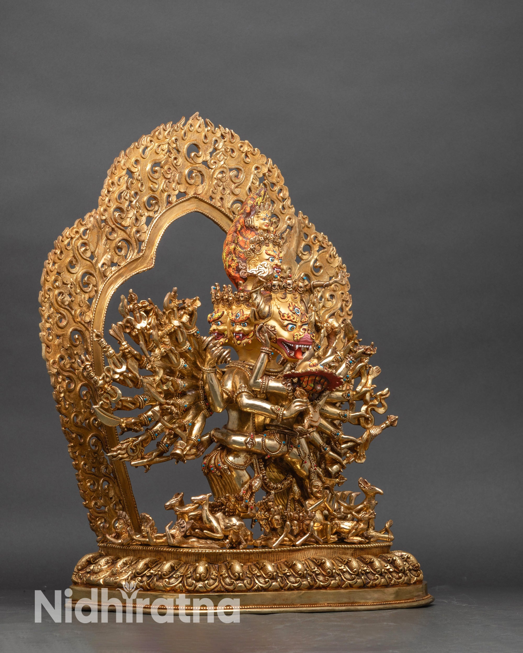 Side view Yab-Yum sculpture with sixteen arms holding sacred ritual implements