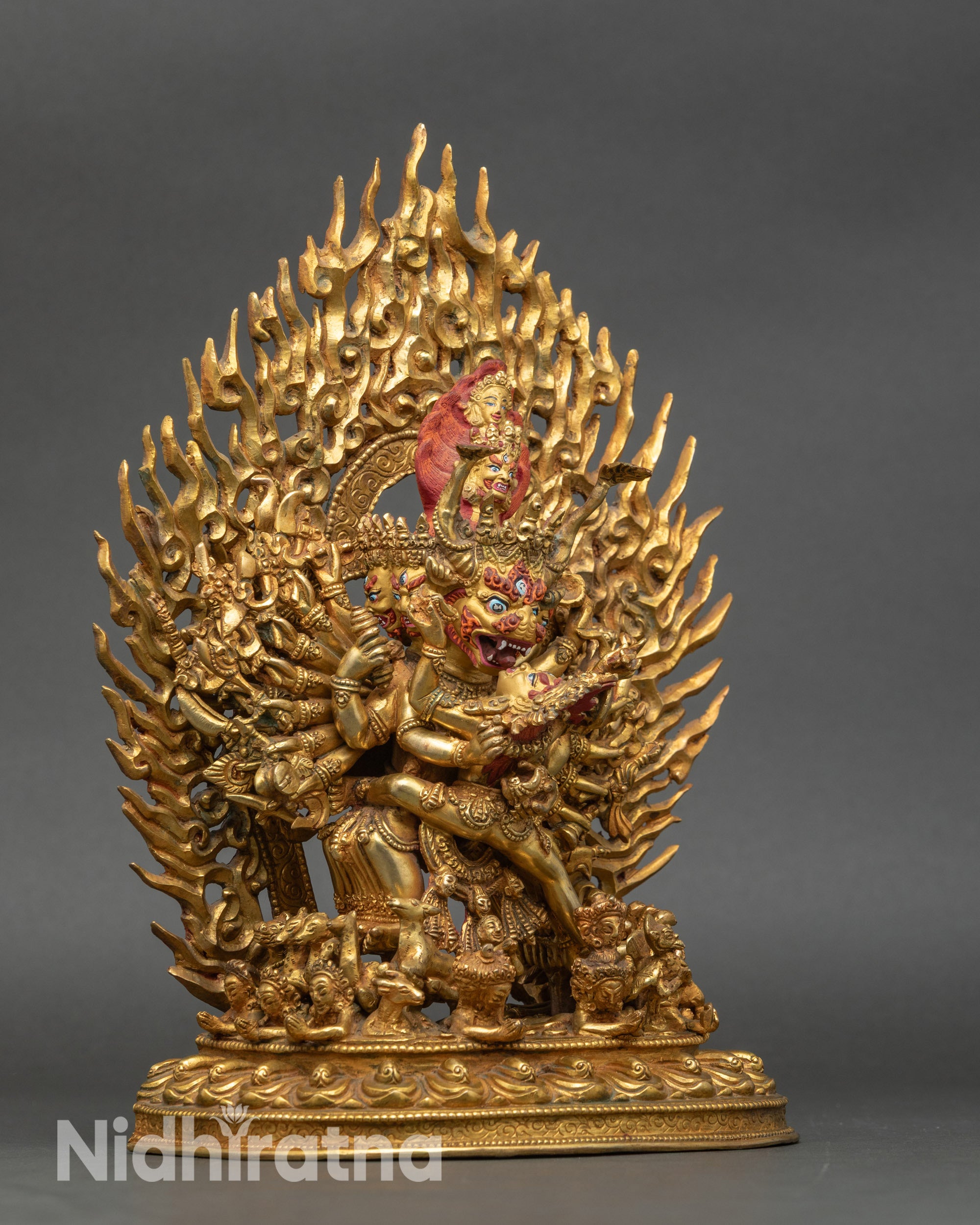 Side view Yamantaka statue holding vajra, sword, and skull cups, Himalayan Buddhist art