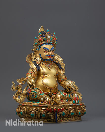 Side view Yellow Dzambhala Statue seated on lotus base with gemstone filigree