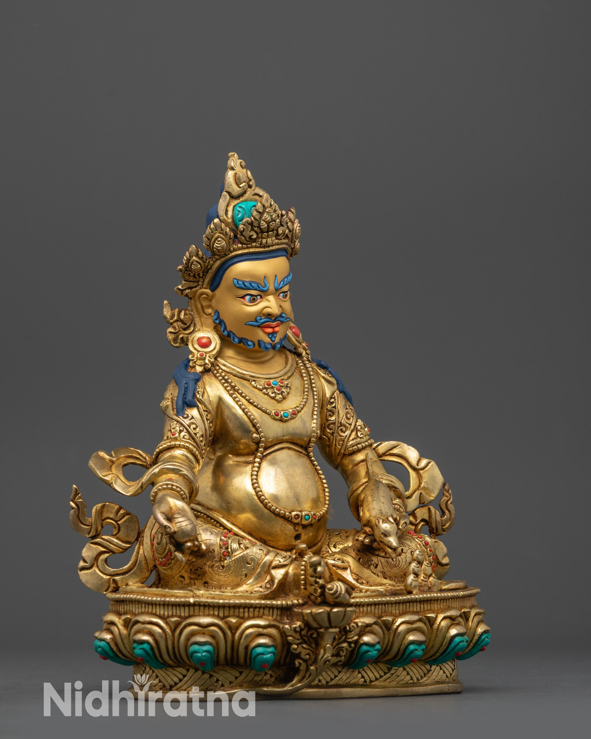 Side view Yellow Jambhala statue with swirling robe, citrion fruits, and mongoose spitting jewels