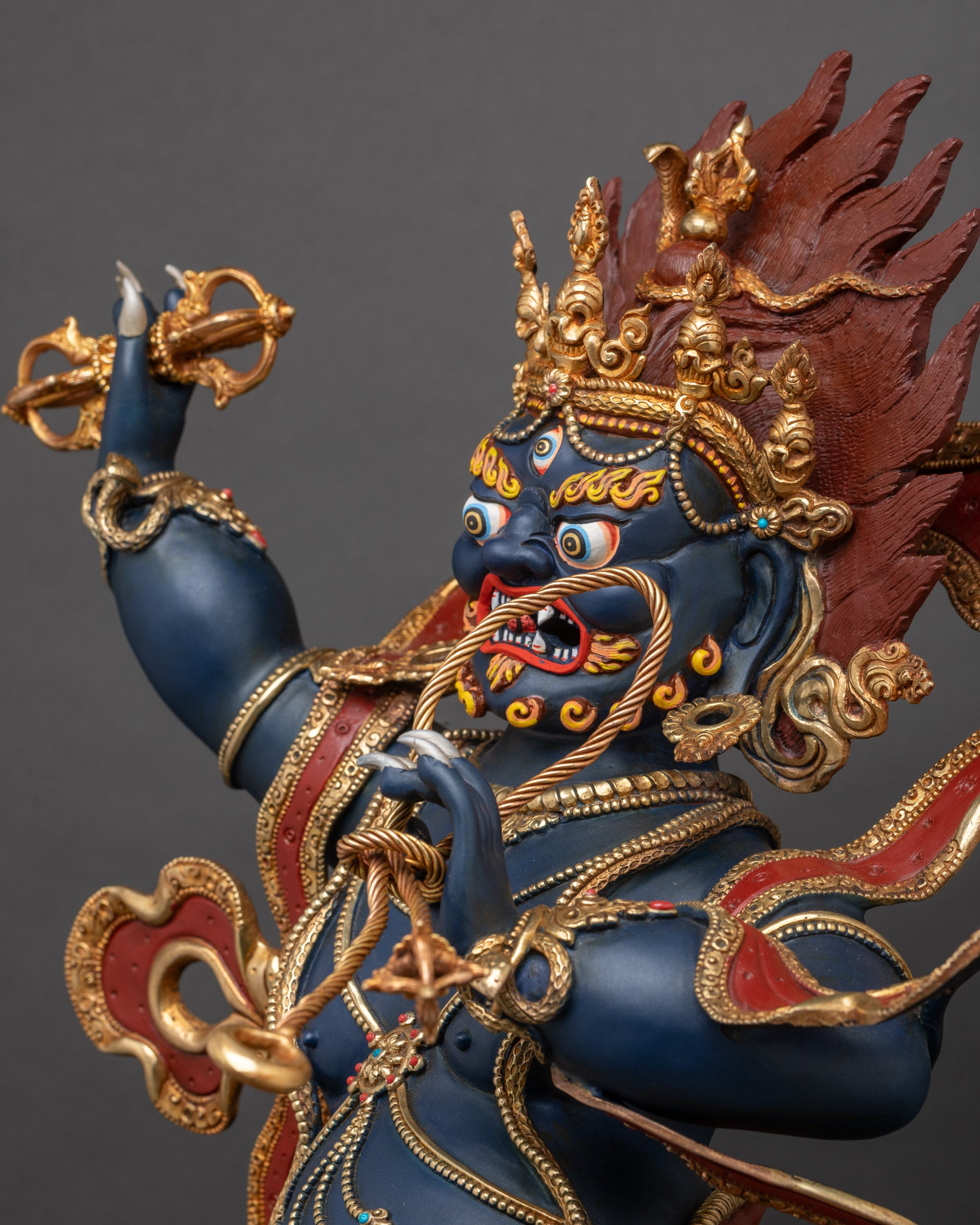 Side view close-up of Vajrapani statue highlighting intricate 3D carvings and dynamic stance