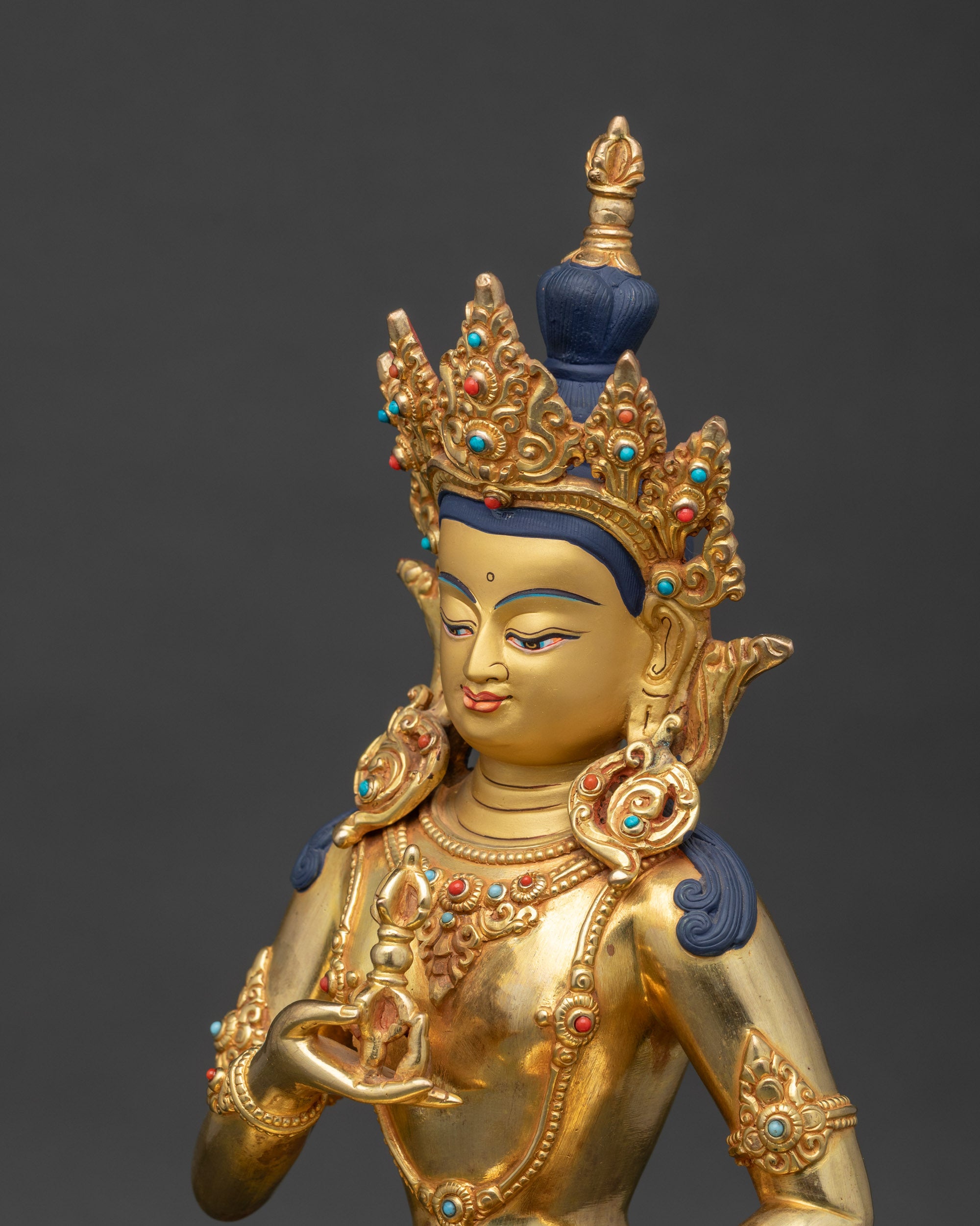 Side view close-up of Vajrasattva robes adorned with semi-precious stones