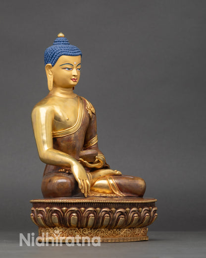 Close up gold-painted face Shakyamuni Buddha with hand-painted details