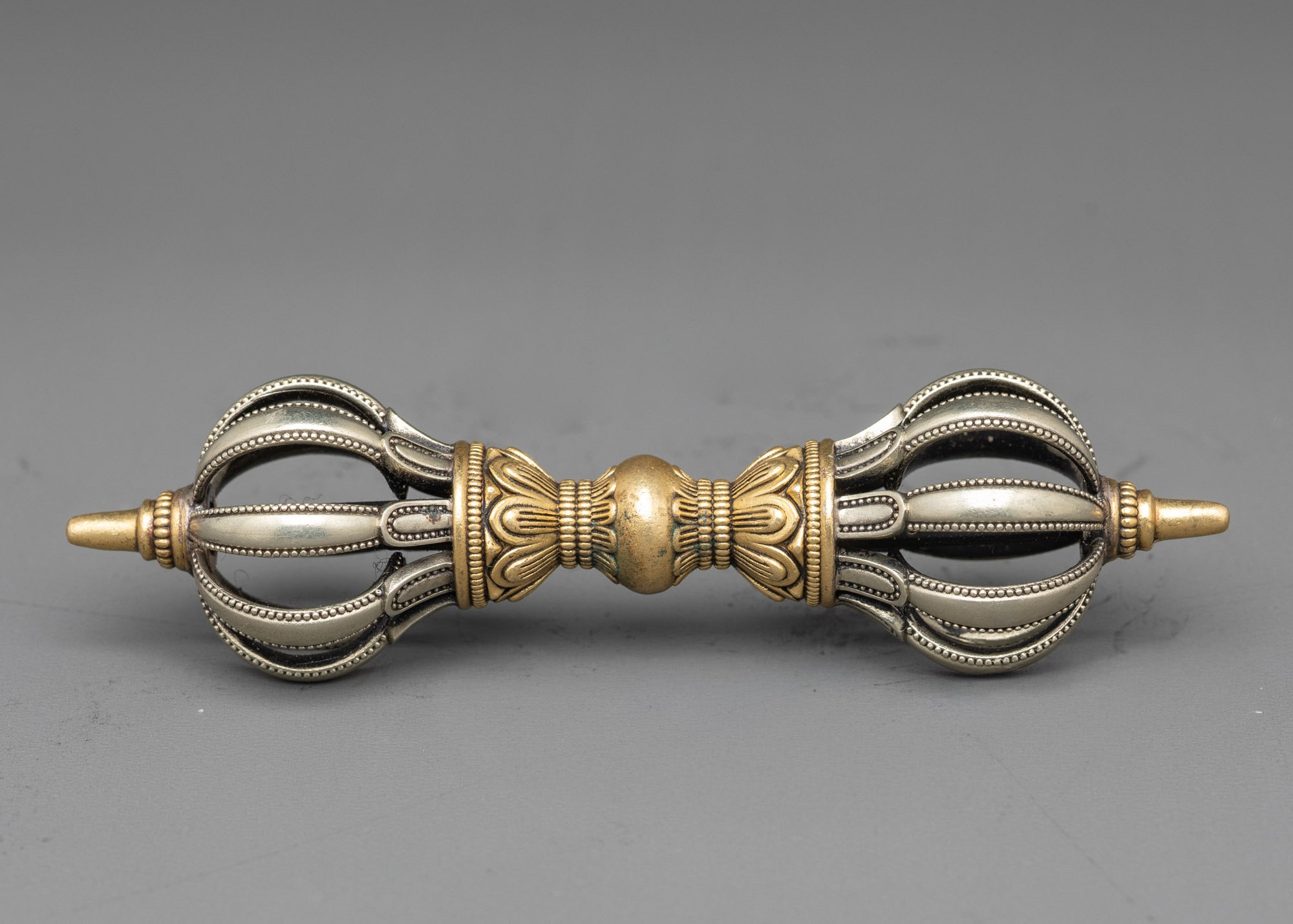 Side view copper Vajra with intricate pattern for sacred Buddhist practice