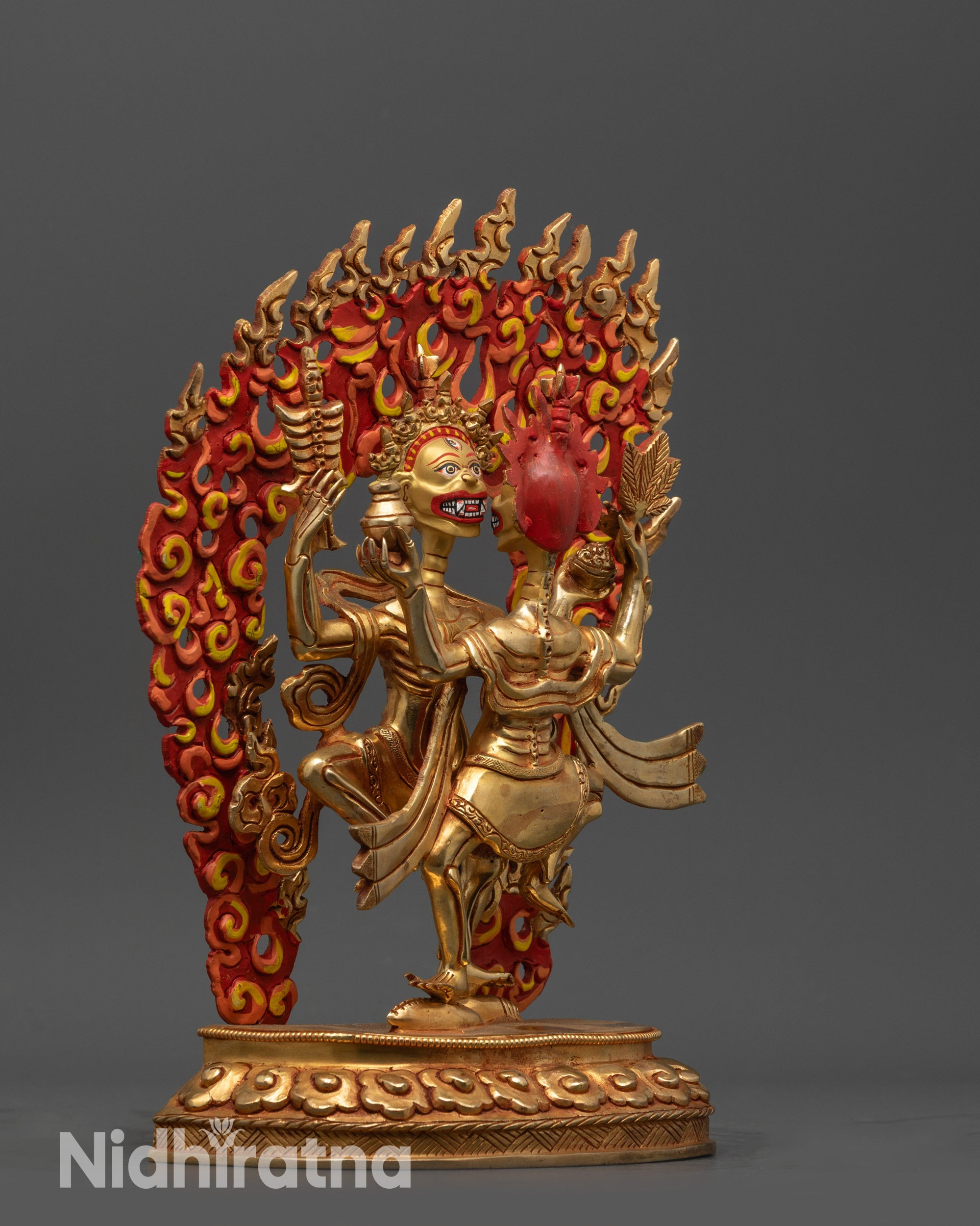 Side view female Chitipati standing on cowry shell with flowing robes and lower silk cloth