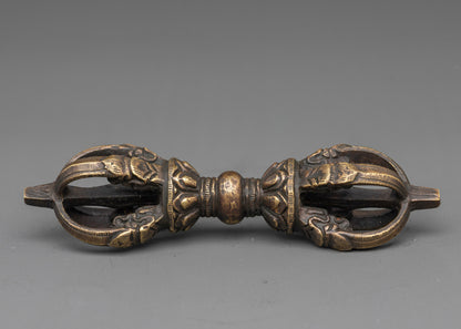 Side view intricate bronze vajra with detailed carvings for tantric ceremonies