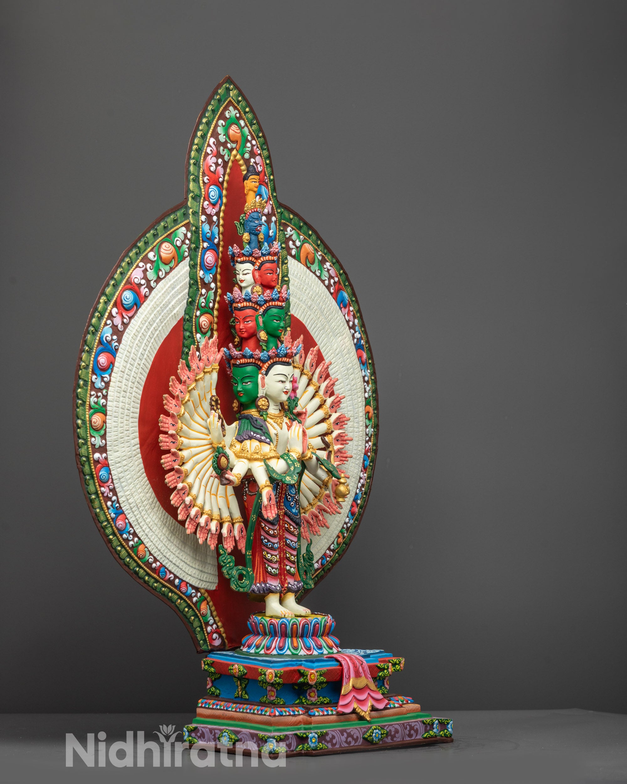 Side view of 1000-Armed Chenrezig Statue on lotus pedestal with detailed halo