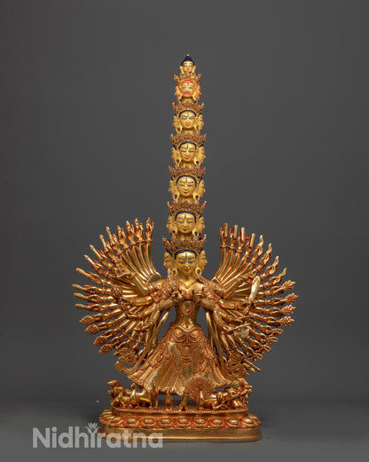 Side view of 1000-Armed Dukar Statue displaying dharma wheel and parasol details
