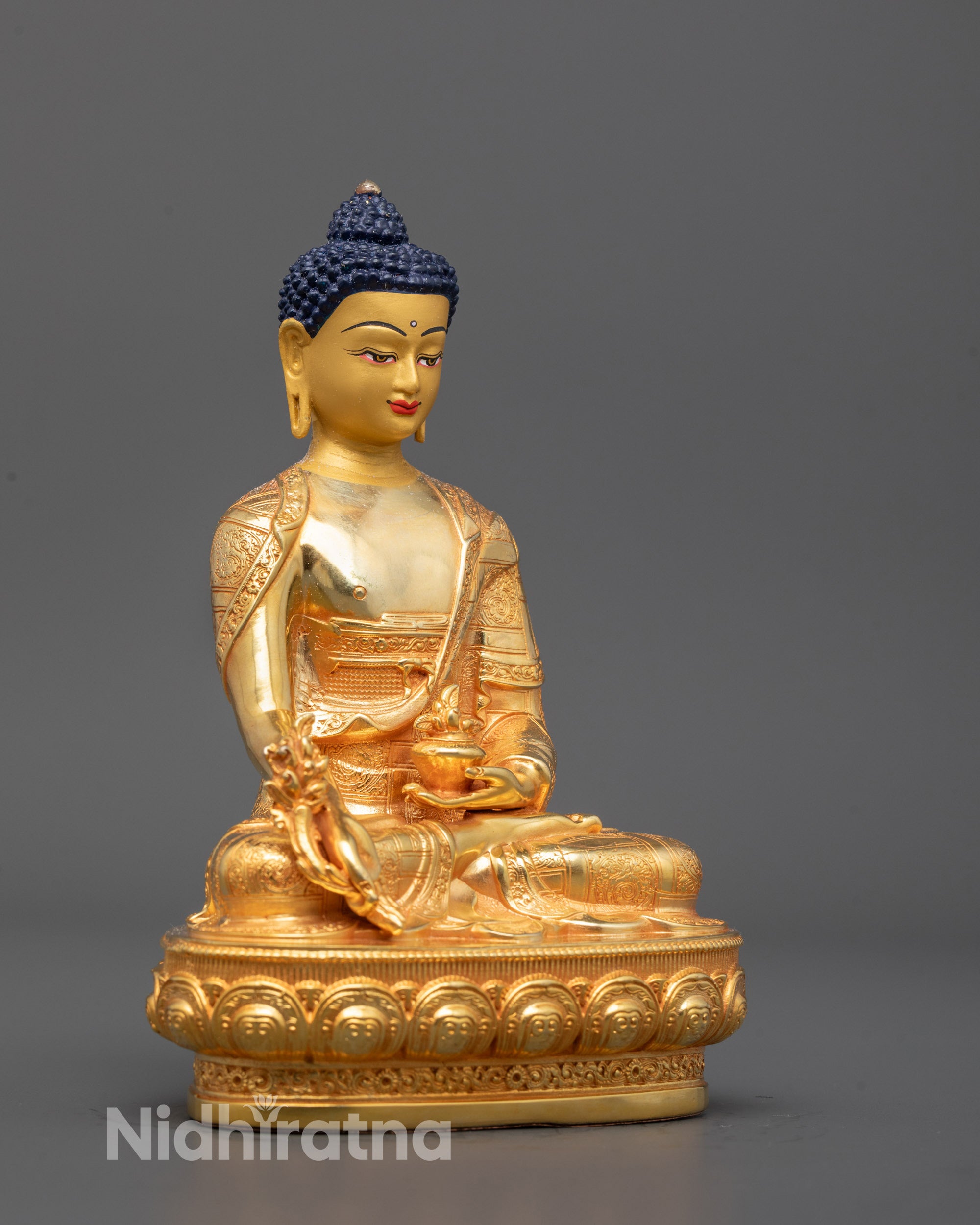 Side view of 24k gold gilded Medicine Buddha statue highlighting the serene facial expression