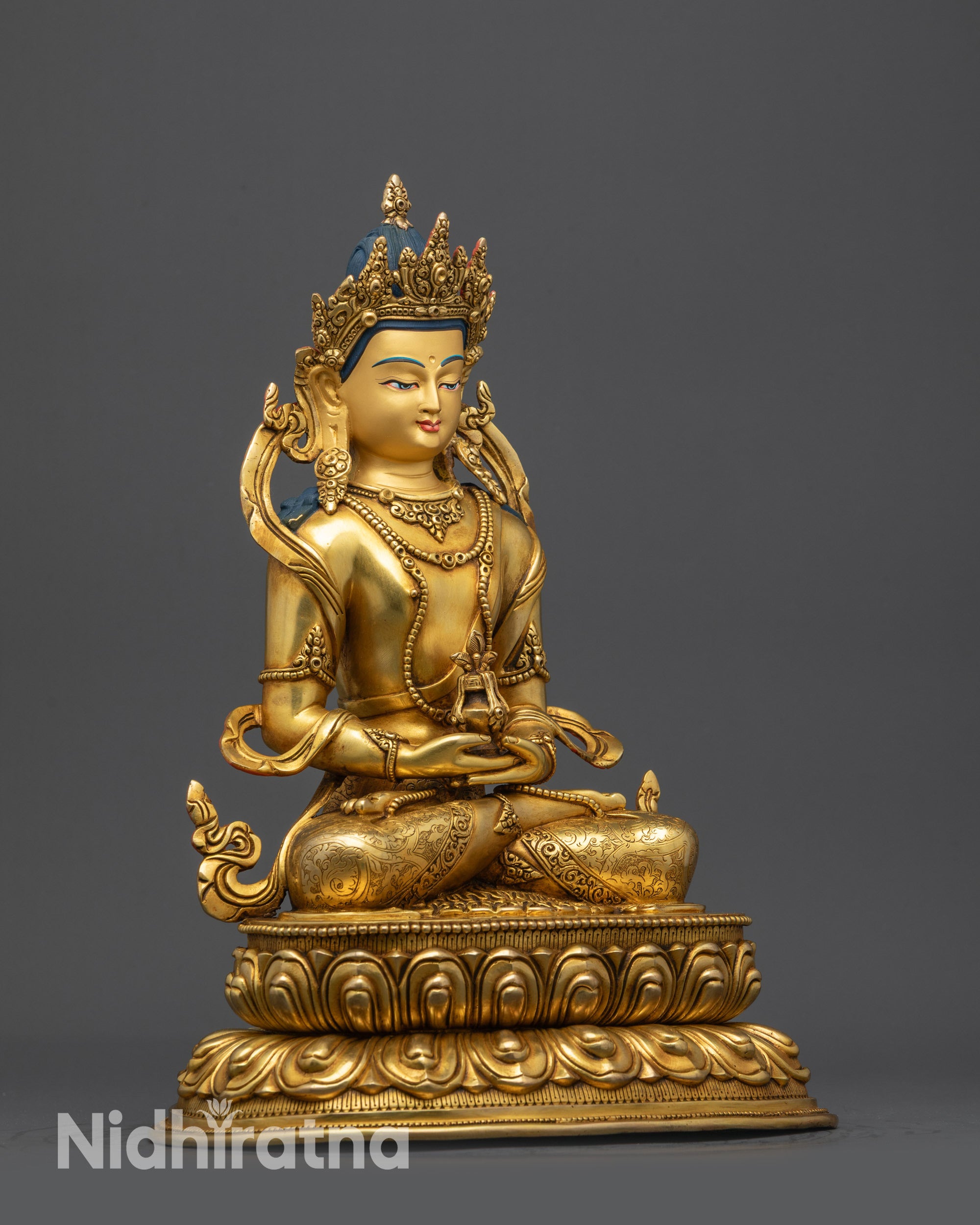 Side view of Amitayus Statue showing swirling robe and jeweled crown details