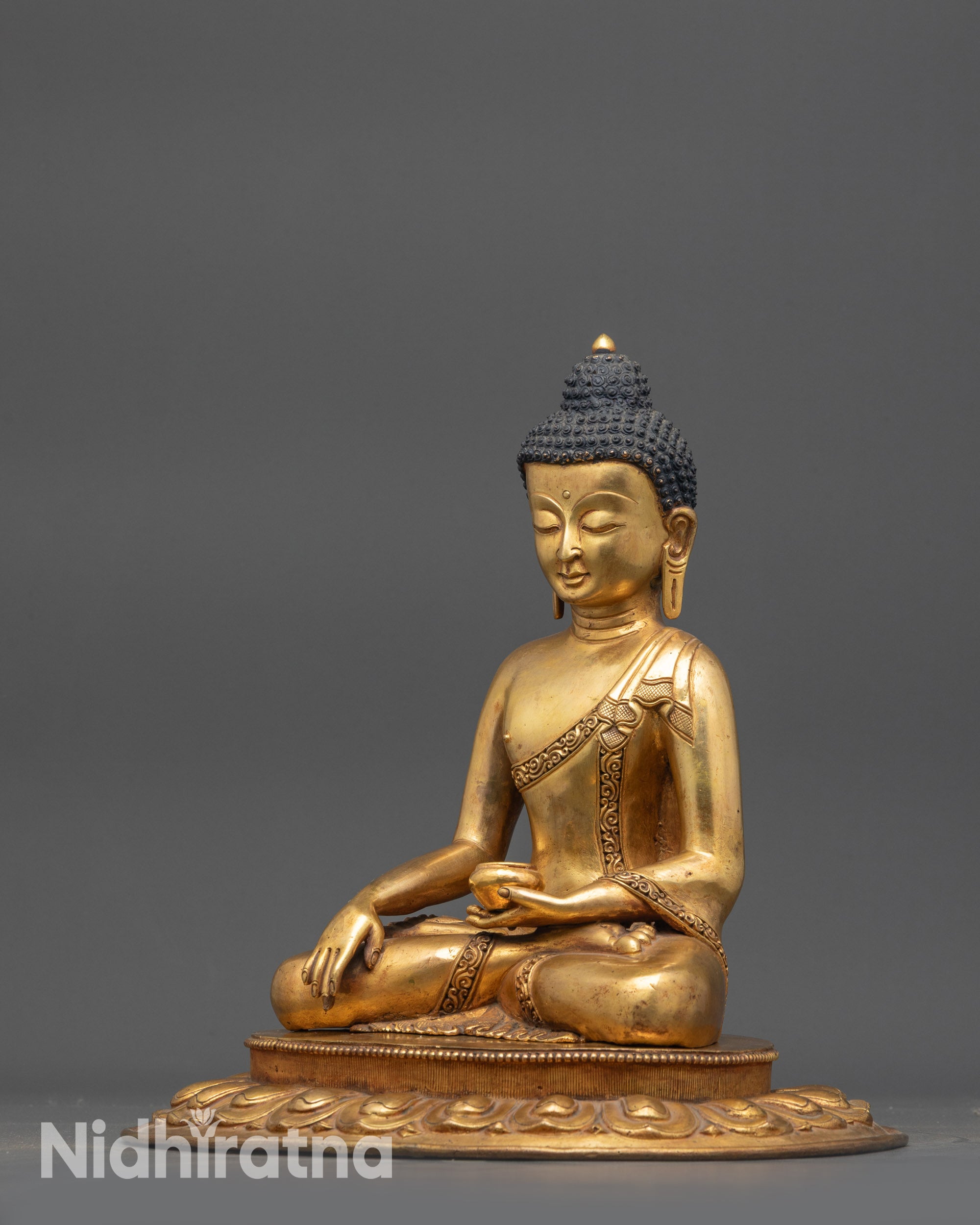Side view of Antique Himalayan Shakyamuni Buddha holding alms bowl in meditation pose