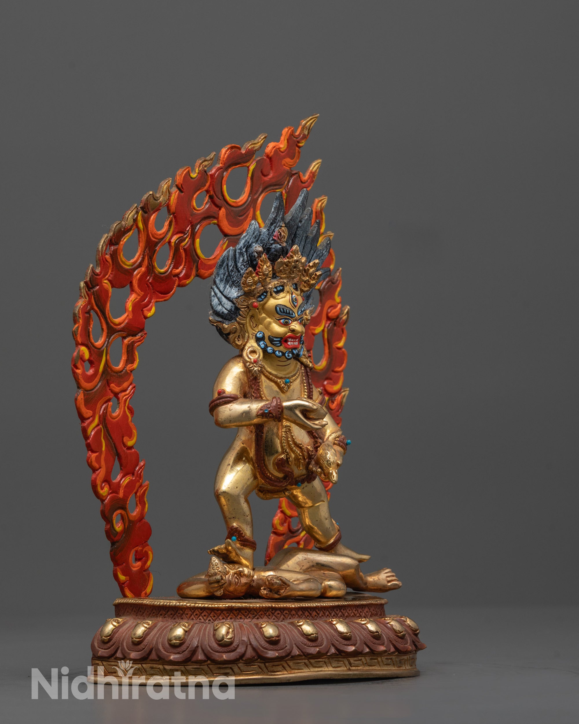 Side view of Artisan-crafted Black Dzambhala statue from Nepal showing deity standing