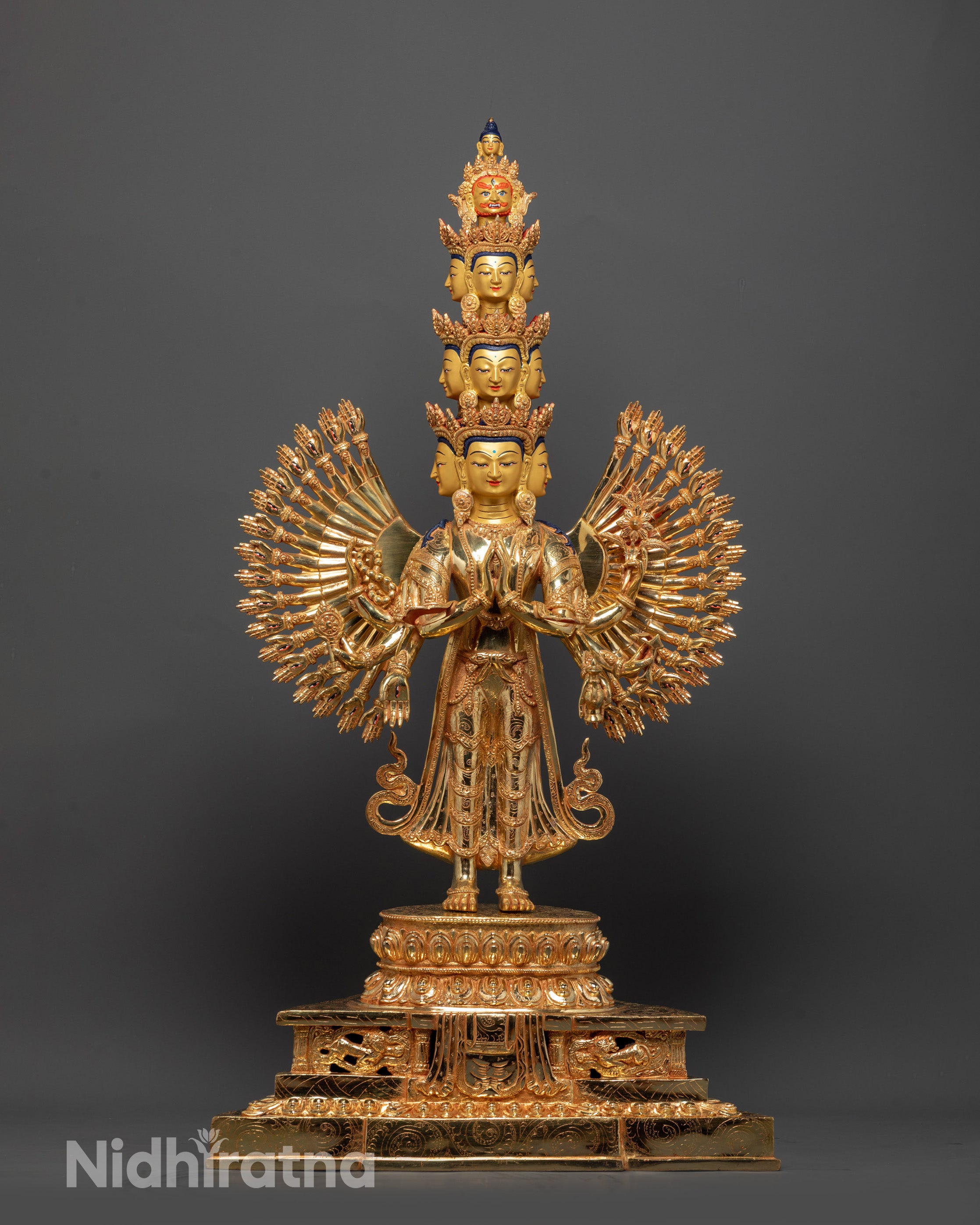Side view of Avalokiteshvara statue highlighting 11 faces and ornate halo motifs