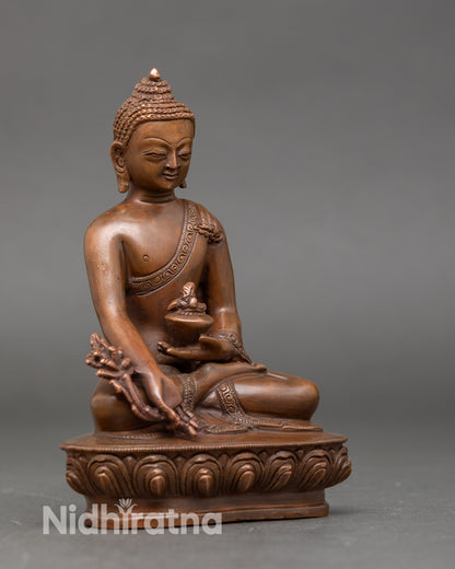 Side view of Bhaisajyaguru statue, meditative posture with medicine bowl in hand