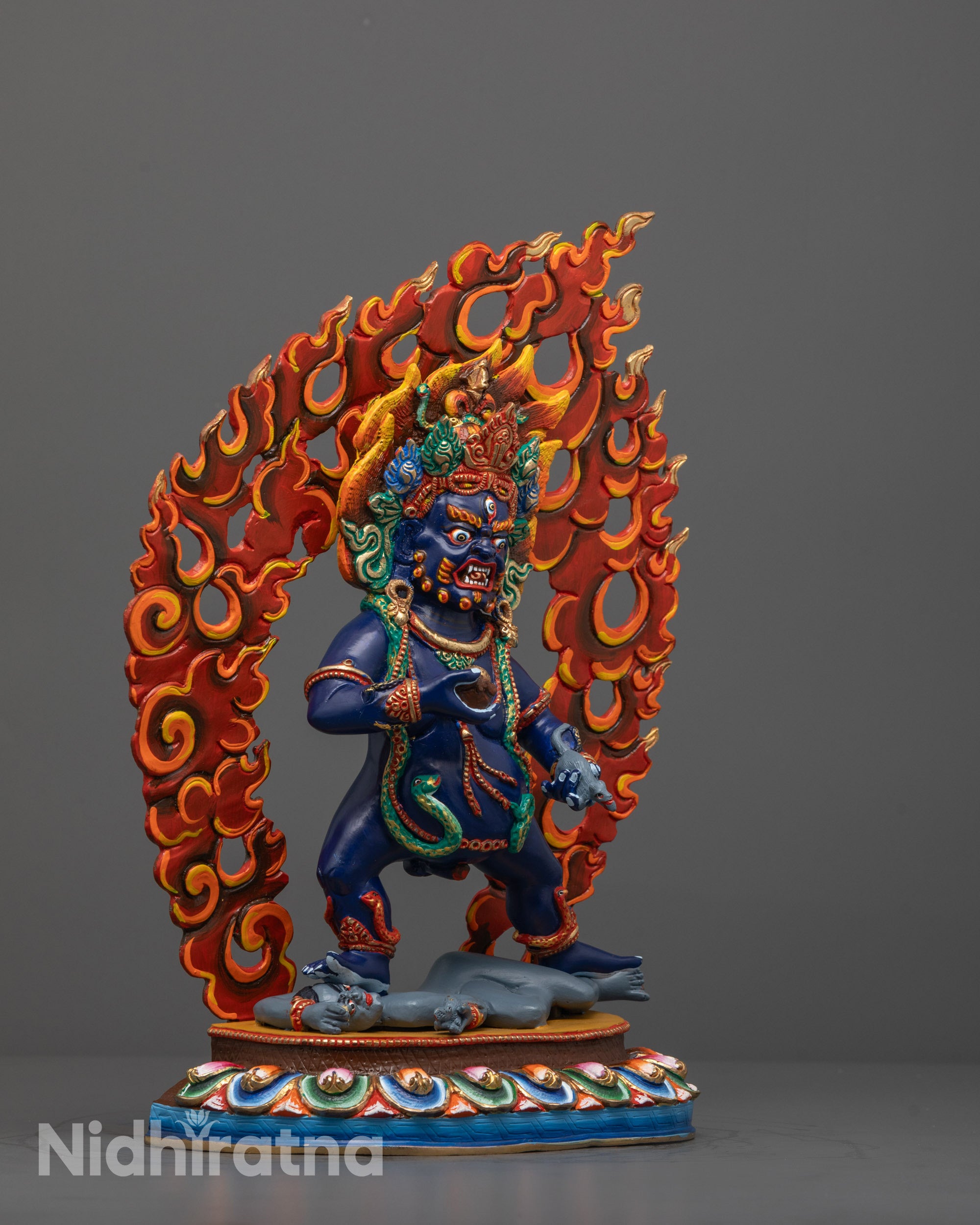 Side view of Black Dzambhala Statue Standing on Human Figure atop Lotus Base