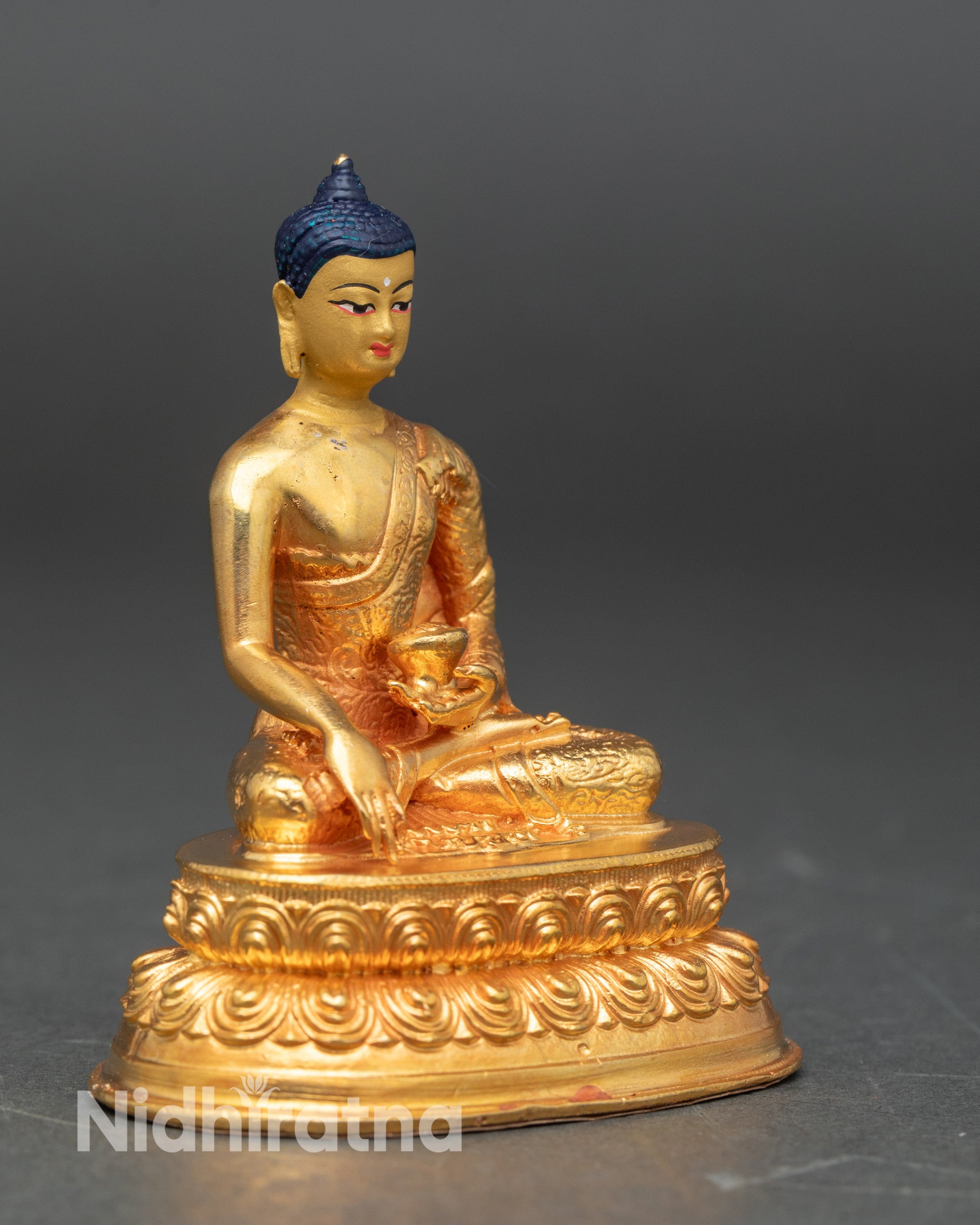 Side view of Buddha altar statue showing lotus pedestal and radiant gilded features