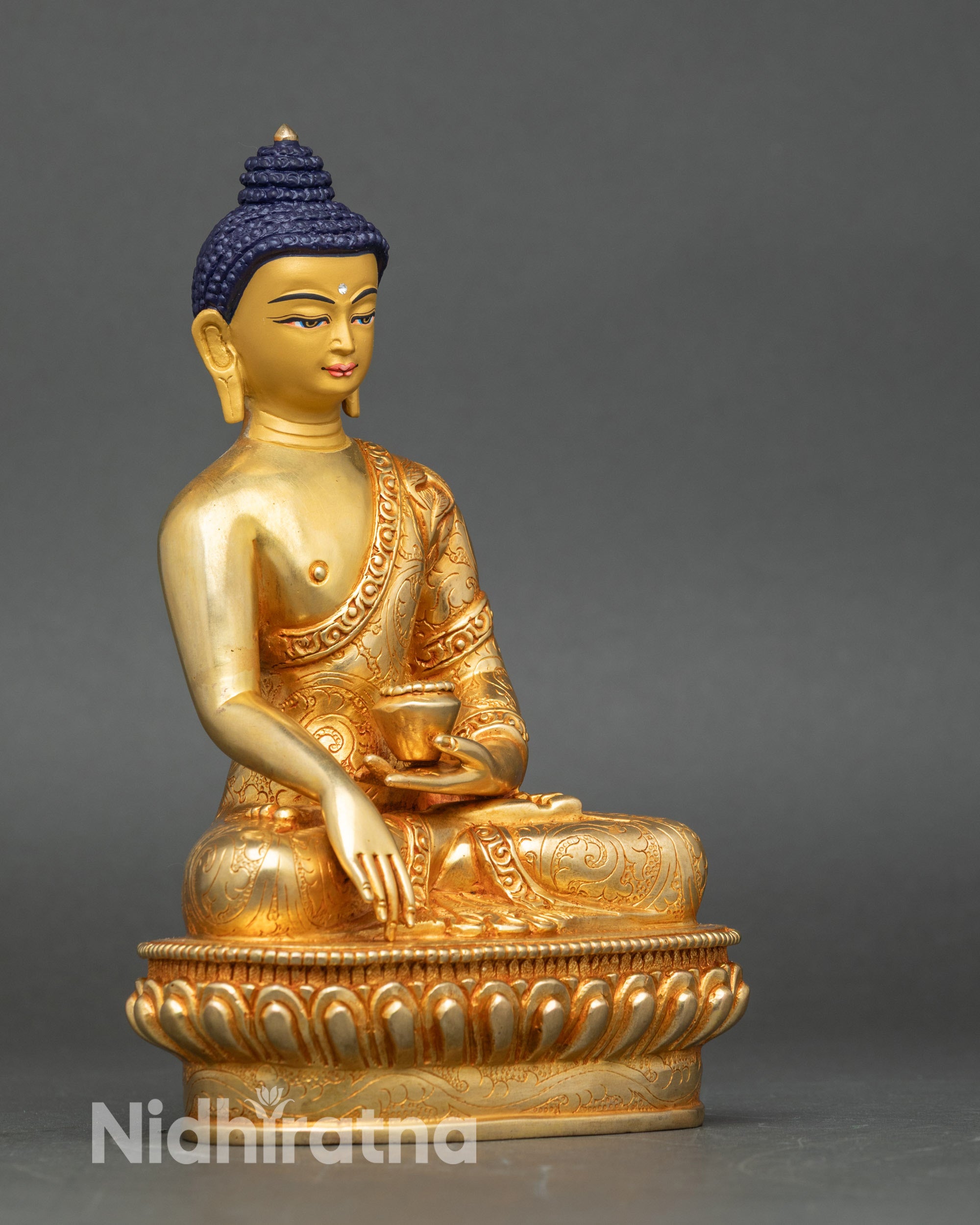 Side view of Buddha statue on ornate pedestal, handcrafted Nepalese copper sculpture