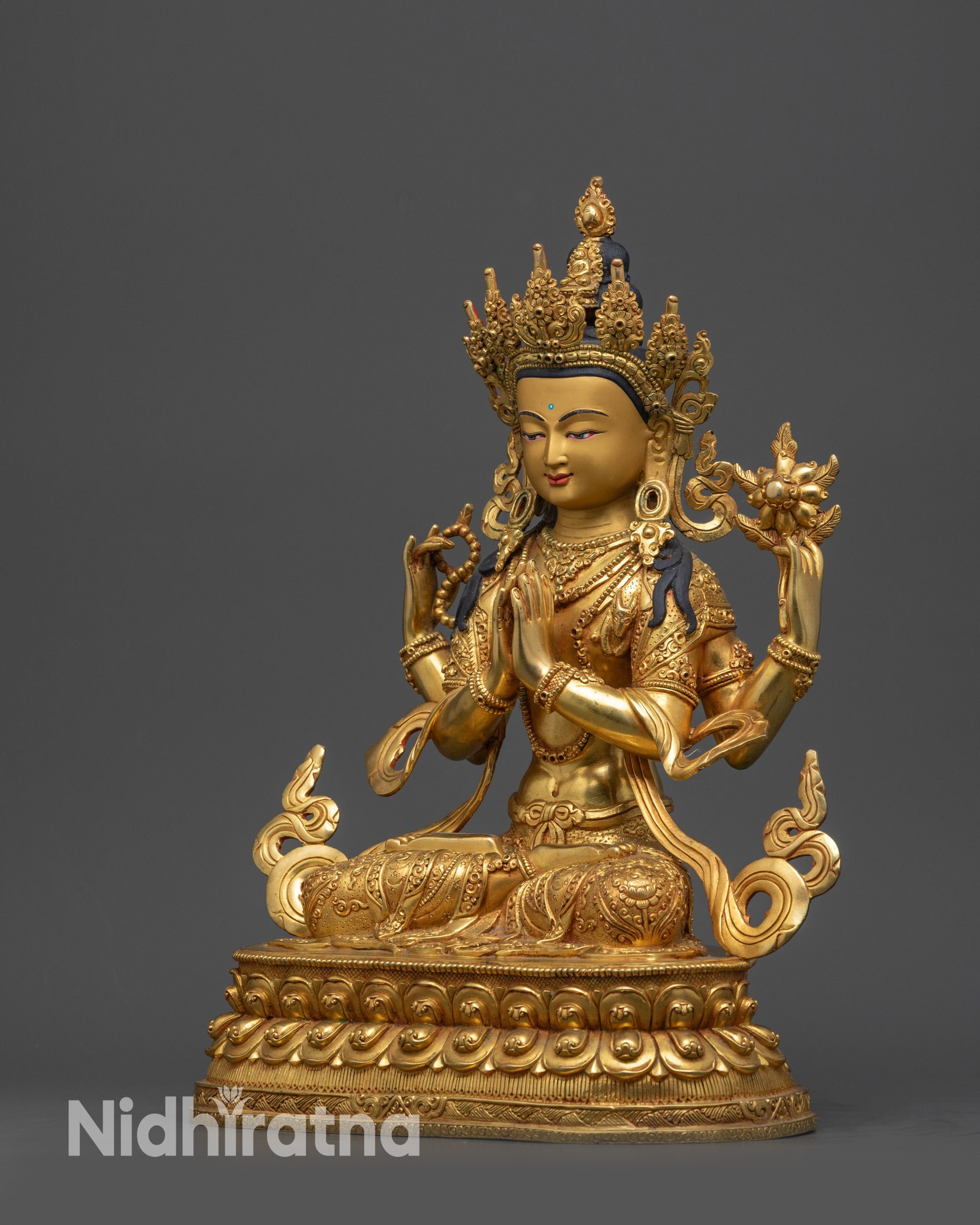 Side view of Chenrezig Statue showing swirling robe and ornate lower garment patterns
