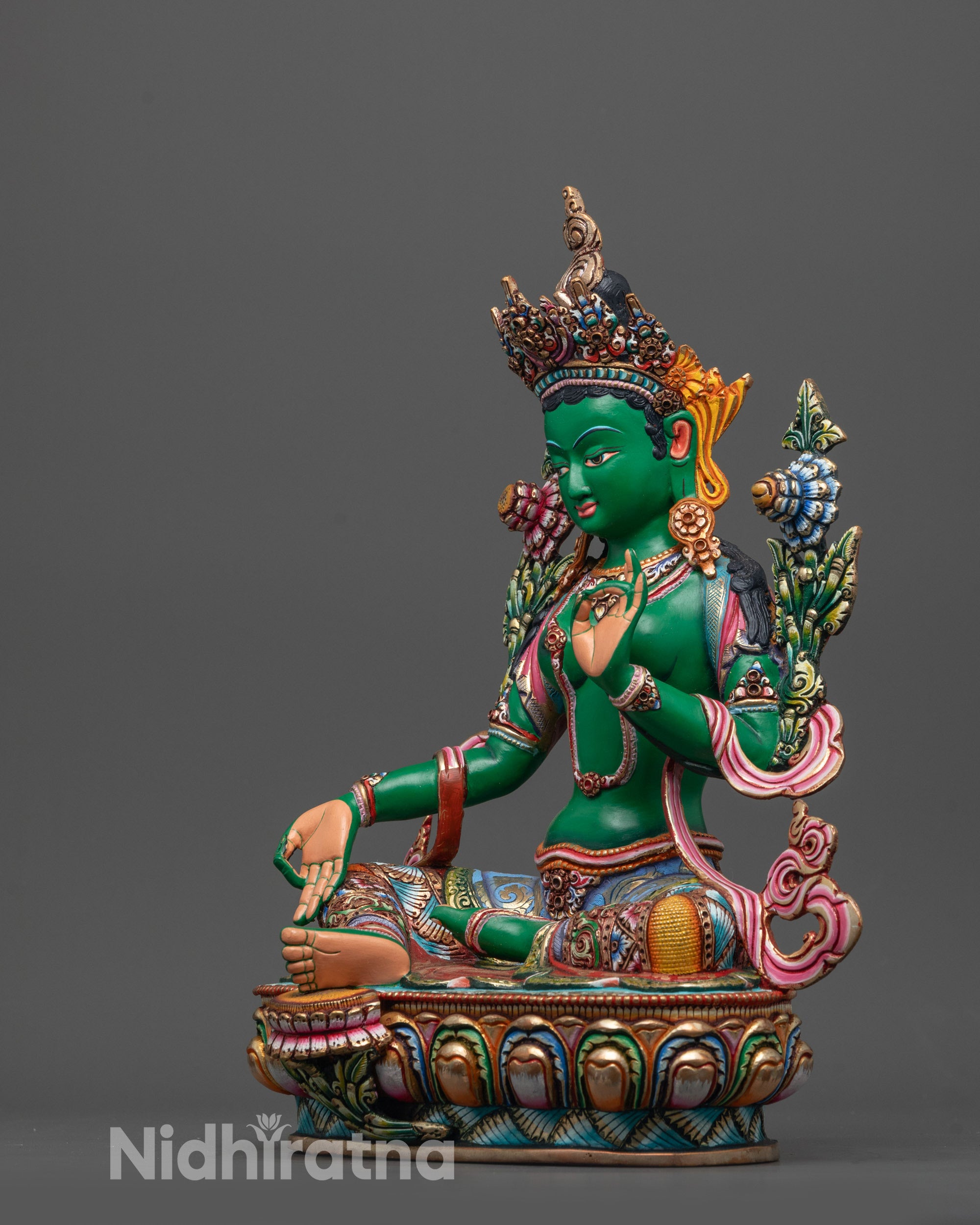 Side view of Coloured Green Tara seated on coloured lotus with intricate carving details