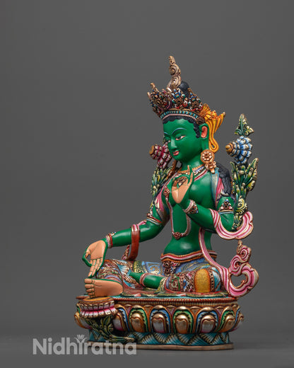 Side view of Coloured Green Tara seated on coloured lotus with intricate carving details