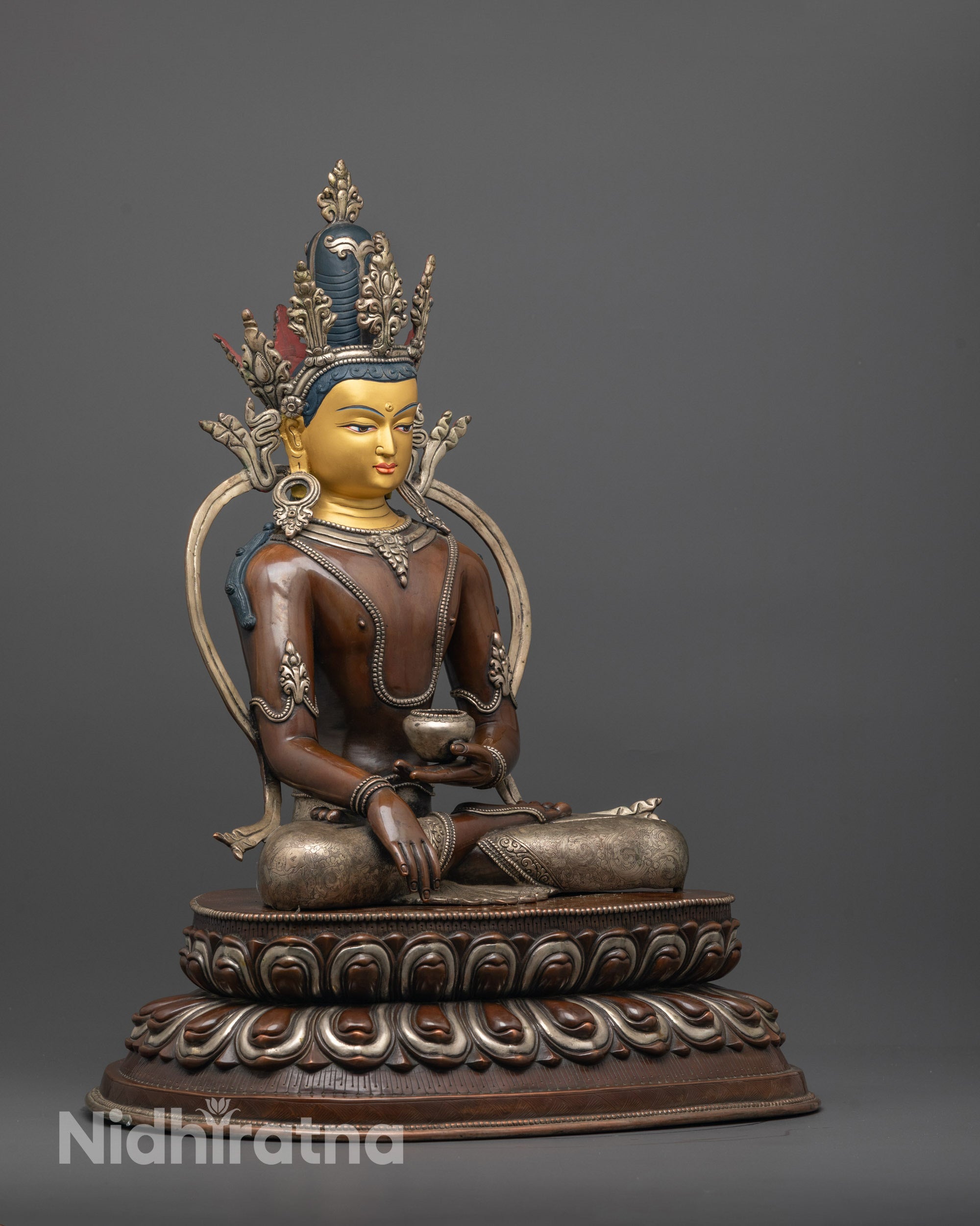 Side view of Crowned Shakyamuni Buddha showing floating robe and Patra bowl in hand