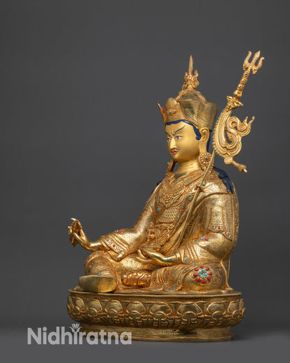 Side view of Divine Padmasambhava statue seated on lotus with gold-gilded face
