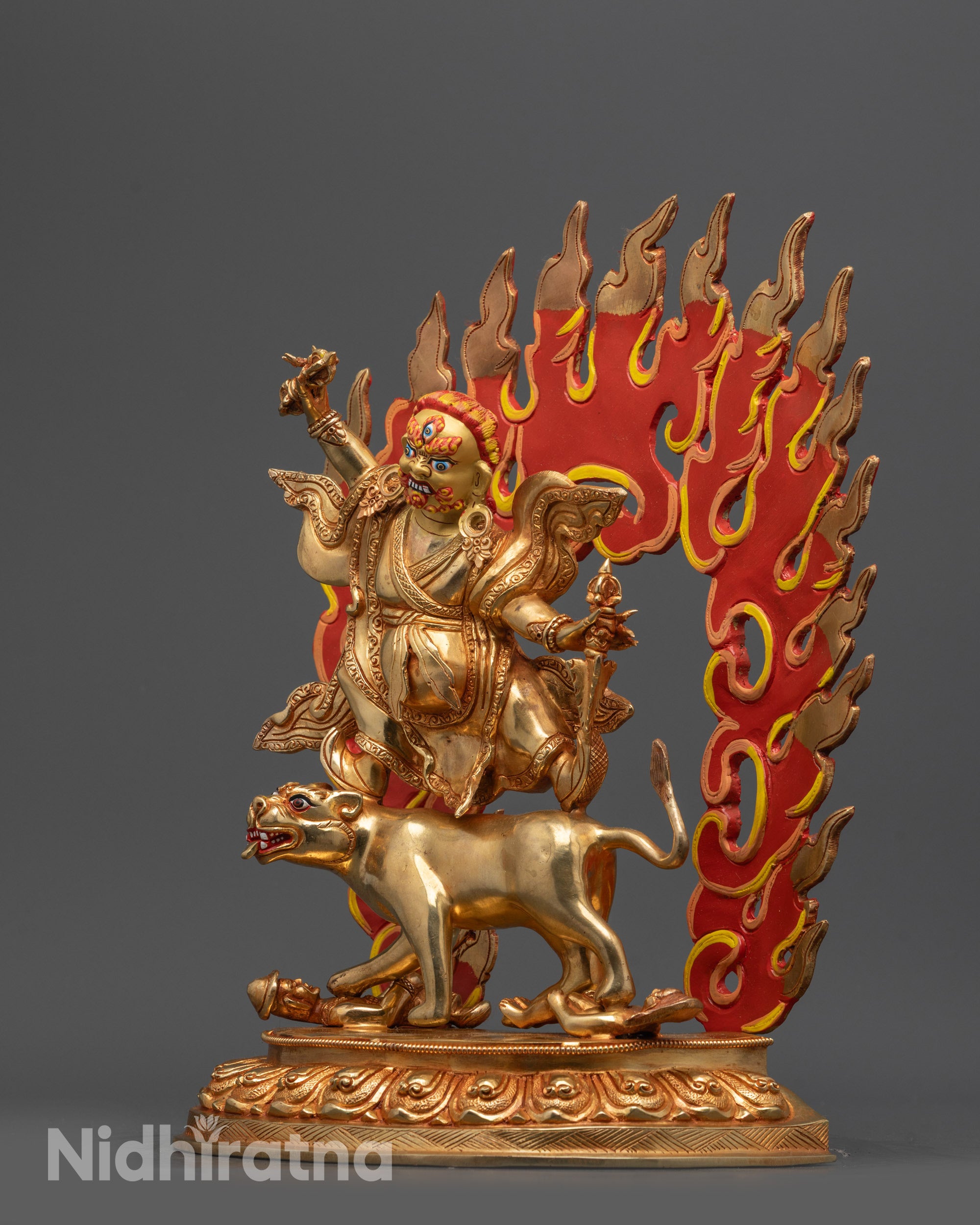 Side view of Dorje Drolo sculpture holding Dorje and Purbha with intricate carved robe