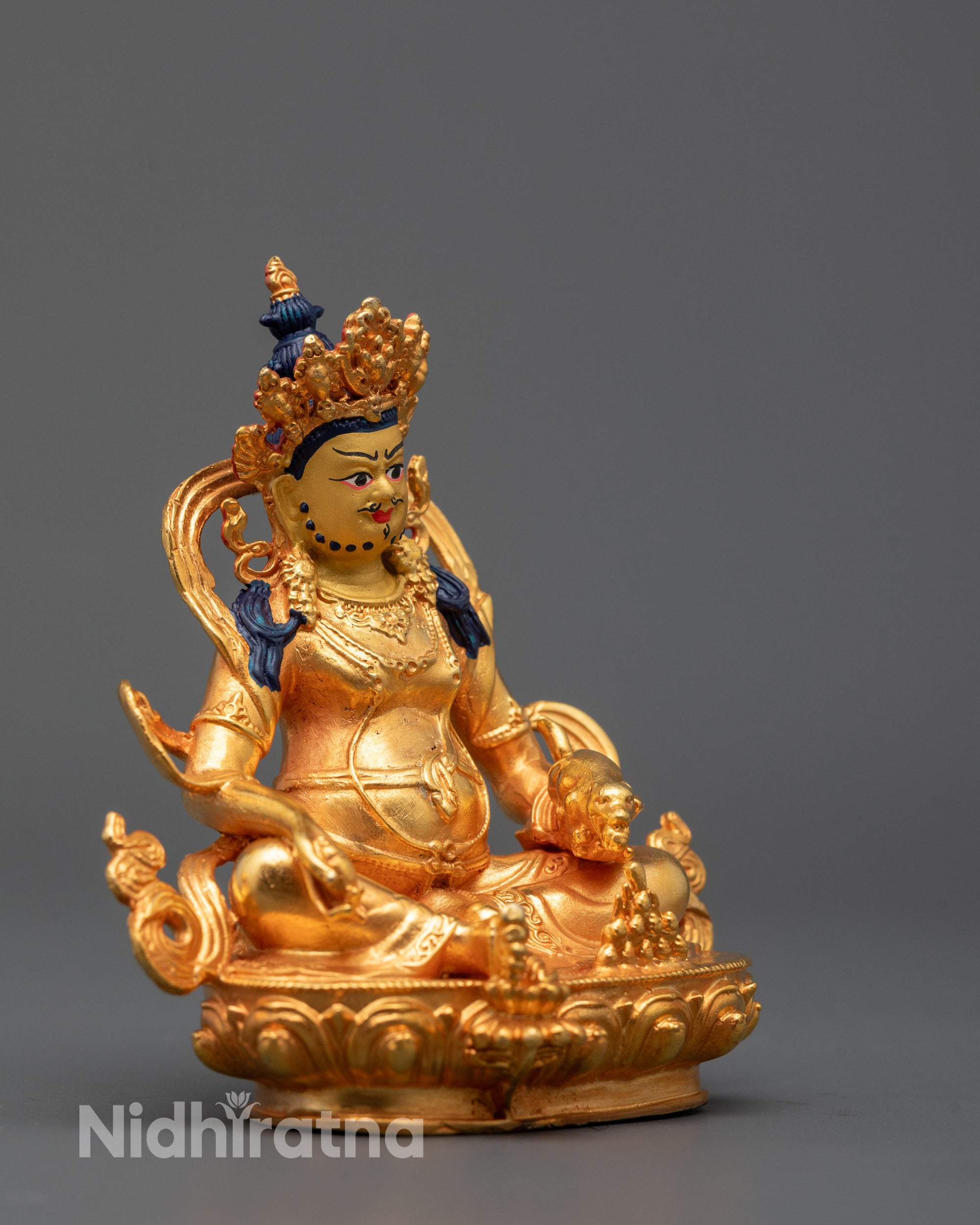 Side view of Dzambhala Buddha statue crafted in Nepal showing lotus base