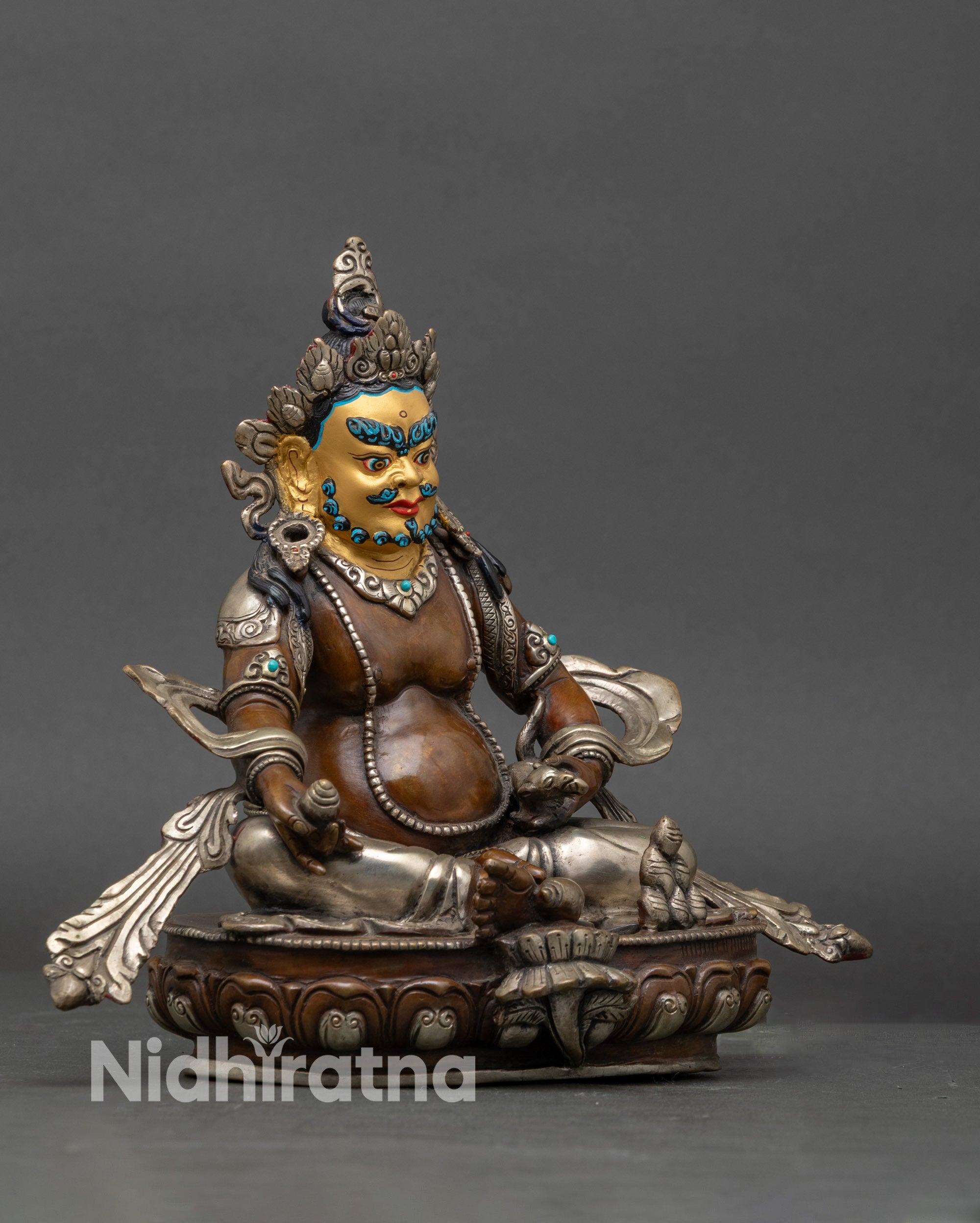 Side view of Dzambhala Deity Statue seated on lotus throne, Nepalese artwork