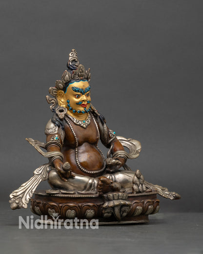 Side view of Dzambhala Deity Statue seated on lotus throne, Nepalese artwork