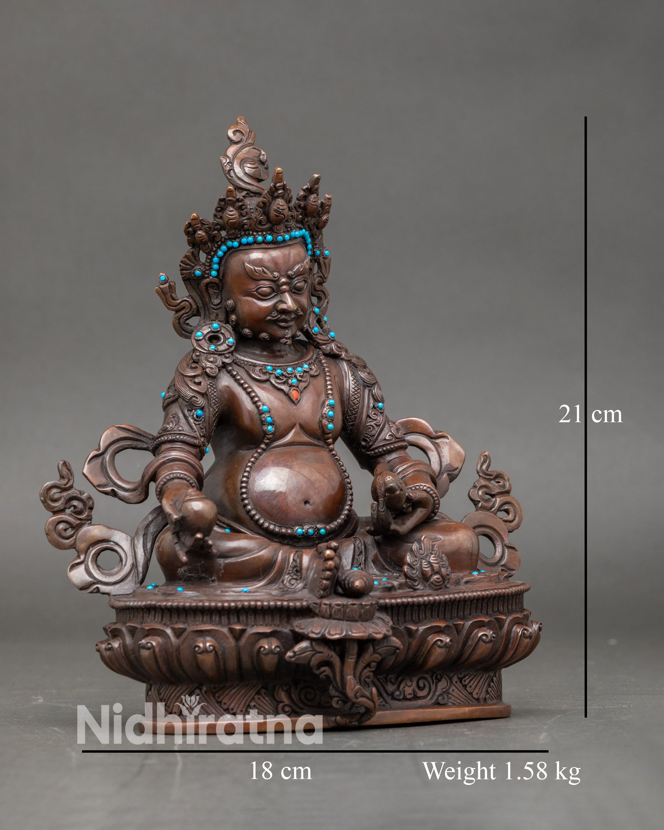 Side view of Dzambhala statue holding mongoose spitting jewels, symbol of prosperity