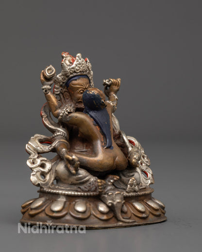 Dzambhala with Yab-Yum Tibetan Buddhist statue highlighting the hollow mantra chamber and silver-plated craftsmanship.

