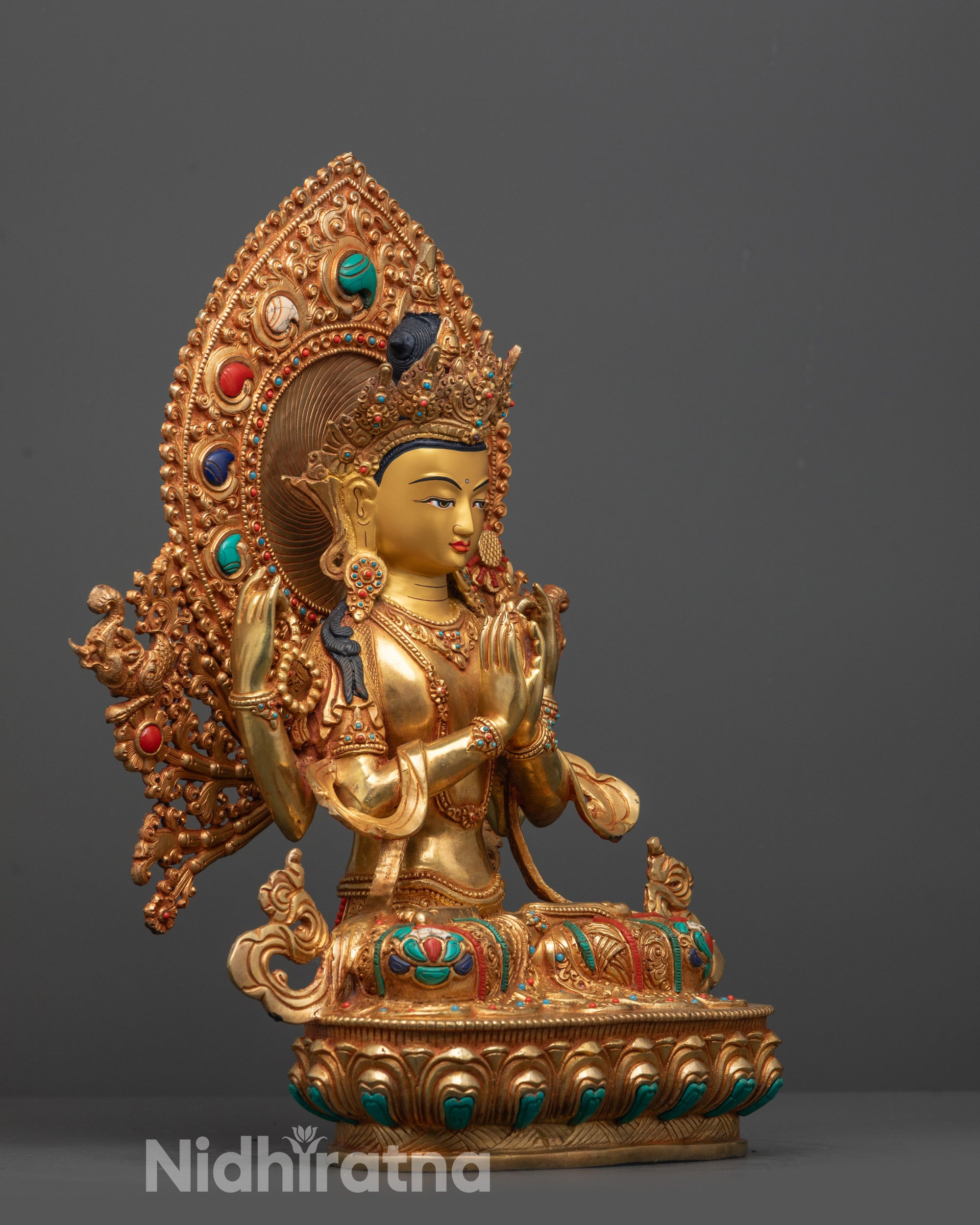 Side view of Four-armed Chenrezig Statue adorned with coral, lapis lazuli, and turquoise