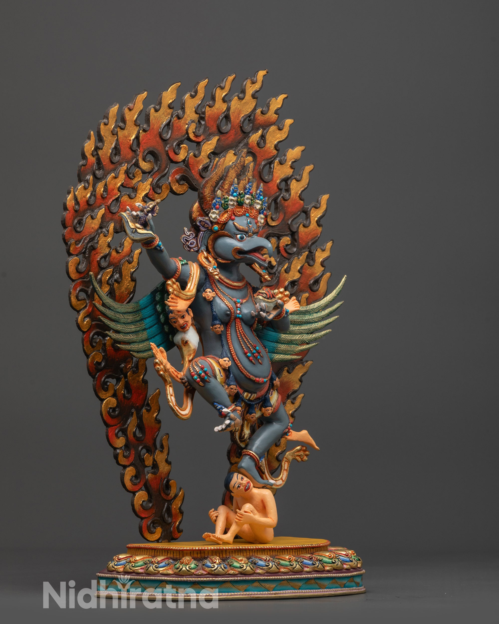 Side view of Garuda Statue holding Kartika Knife and skull cup on lotus seat
