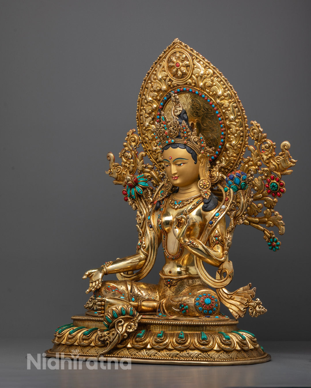 Side view of Green Tara Statue adorned with semi-precious stones