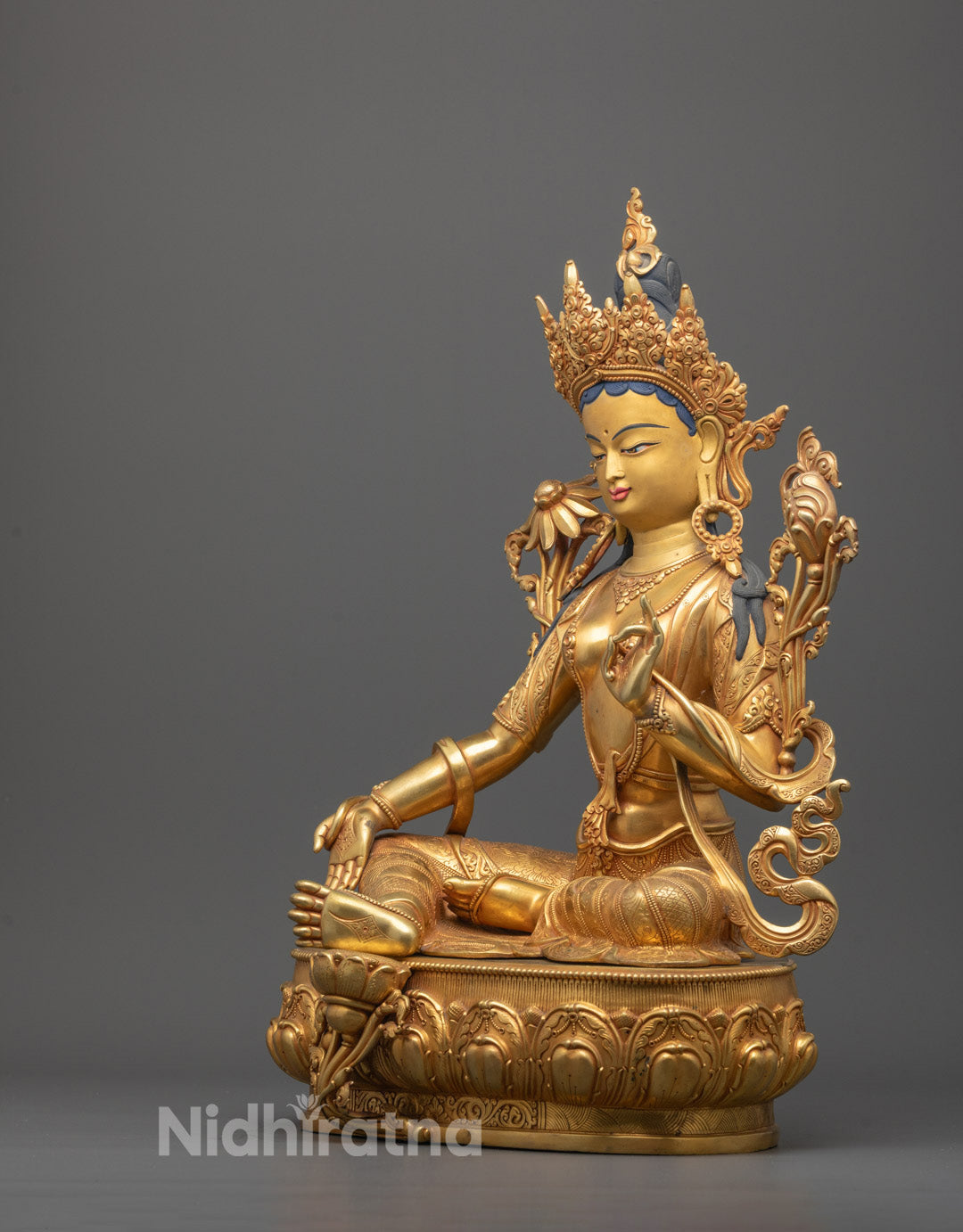 Side view of Green Tara Tibetan Buddhist statue handcrafted in Nepal, featuring delicate lotus seat