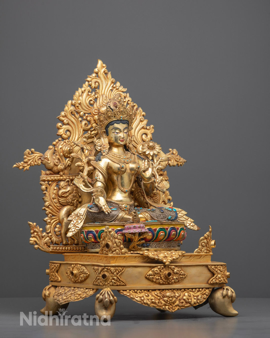 Side view of Green Tara sculpture showing detailed semi-precious stone inlays