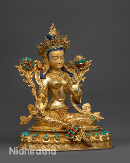 Side view of Green Tara sculpture showing floating robe and Utpala flower