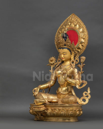 Side view of Green Tara sculpture showing lotus seat and robe with semi-precious stones