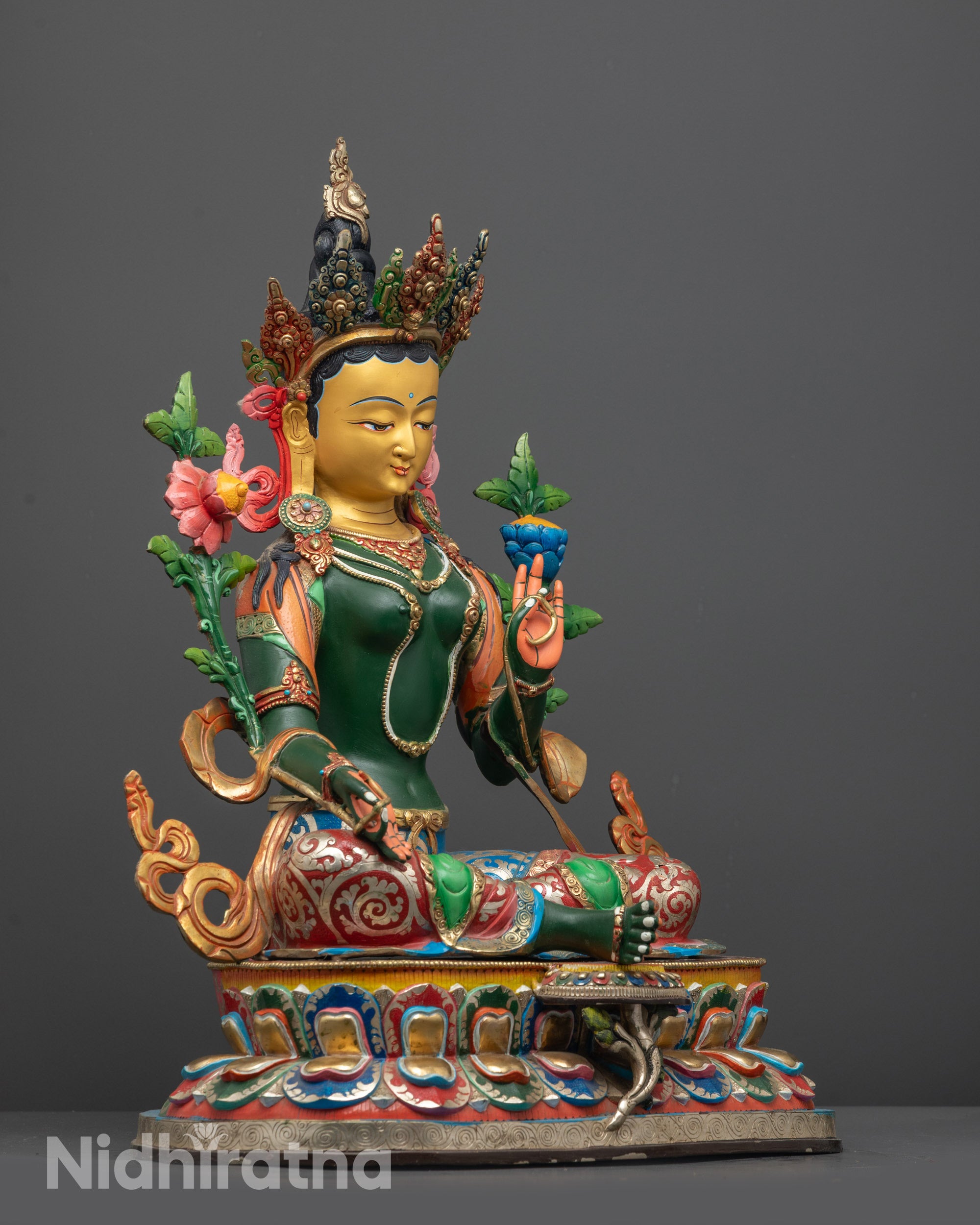 Side view of Green Tara statue highlighting floating robe and intricate lower garment