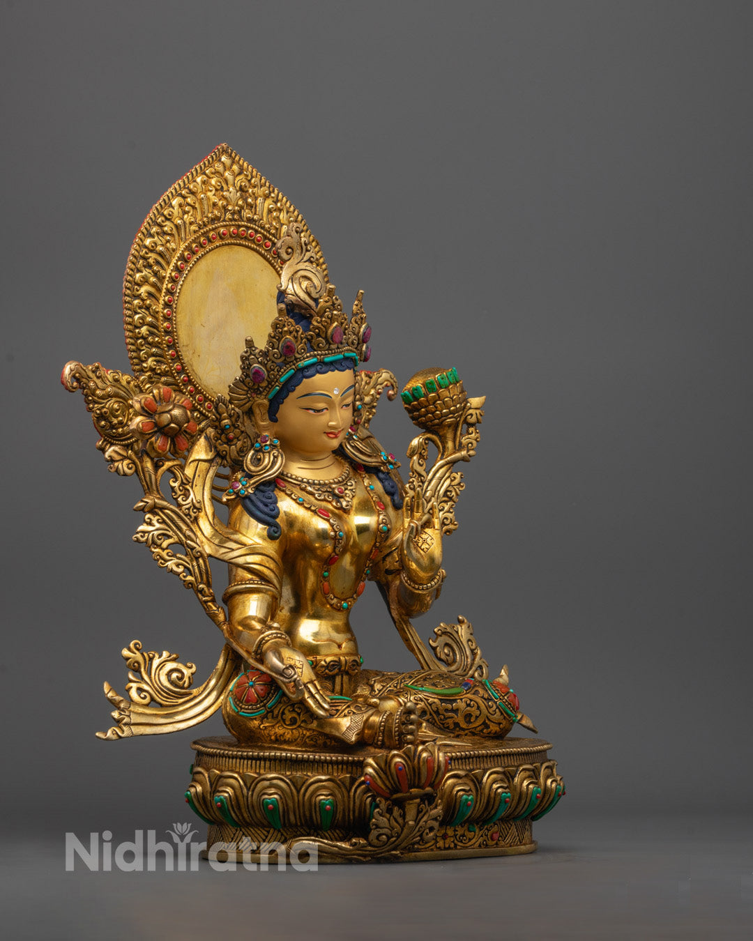 Side view of Green Tara statue showing meditative posture and consecration chamber